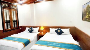 A hotel room with two beds, wooden ceiling, white walls, and a window with blinds. - HG Hostel and Motobikes (Ha Giang 1)