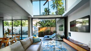 A modern living room with a sofa, coffee table, and TV.
