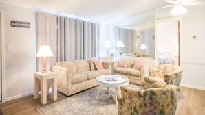 A living room with a sofa, armchairs, a coffee table, and lamps. - 3 BR 2 Bath Home featuring spacious deck 2 living areas 2 Community pools (Ocean City)