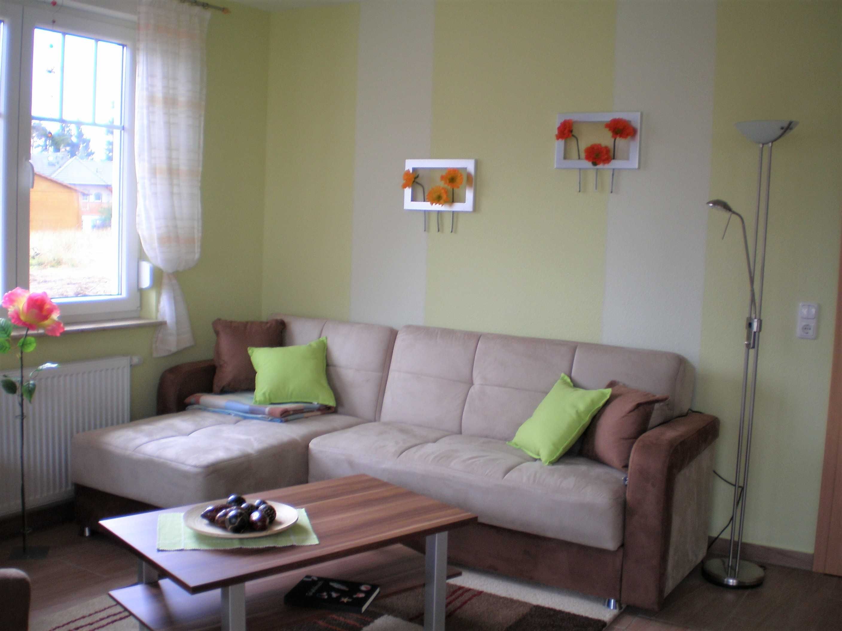 A living room with a sofa, a coffee table, and a floor lamp.
