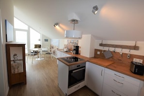Fridge, stovetop, dishwasher, coffee/tea maker