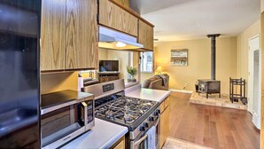 A modern kitchen with wooden cabinets, a stainless steel stove, and a built-in microwave. - Base Camp Lassen Home 13 Mi to Volcanic Nat'l Park (Shingletown)