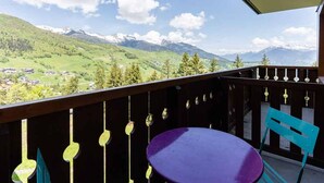 A balcony with a view of a mountainous landscape.