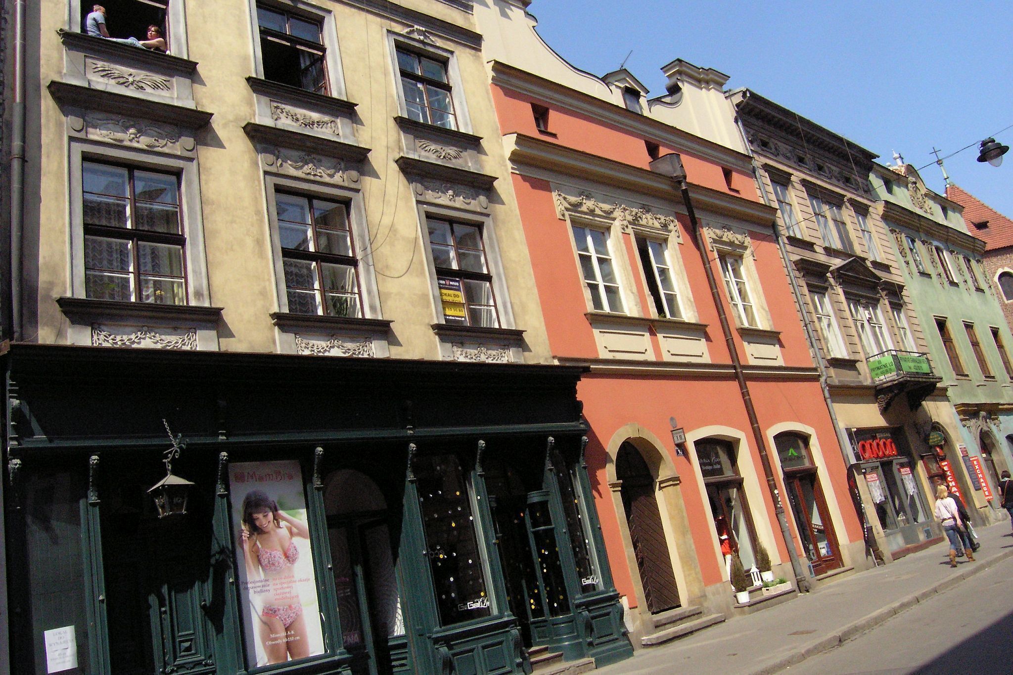 A row of historic buildings with ornate facades and large windows.