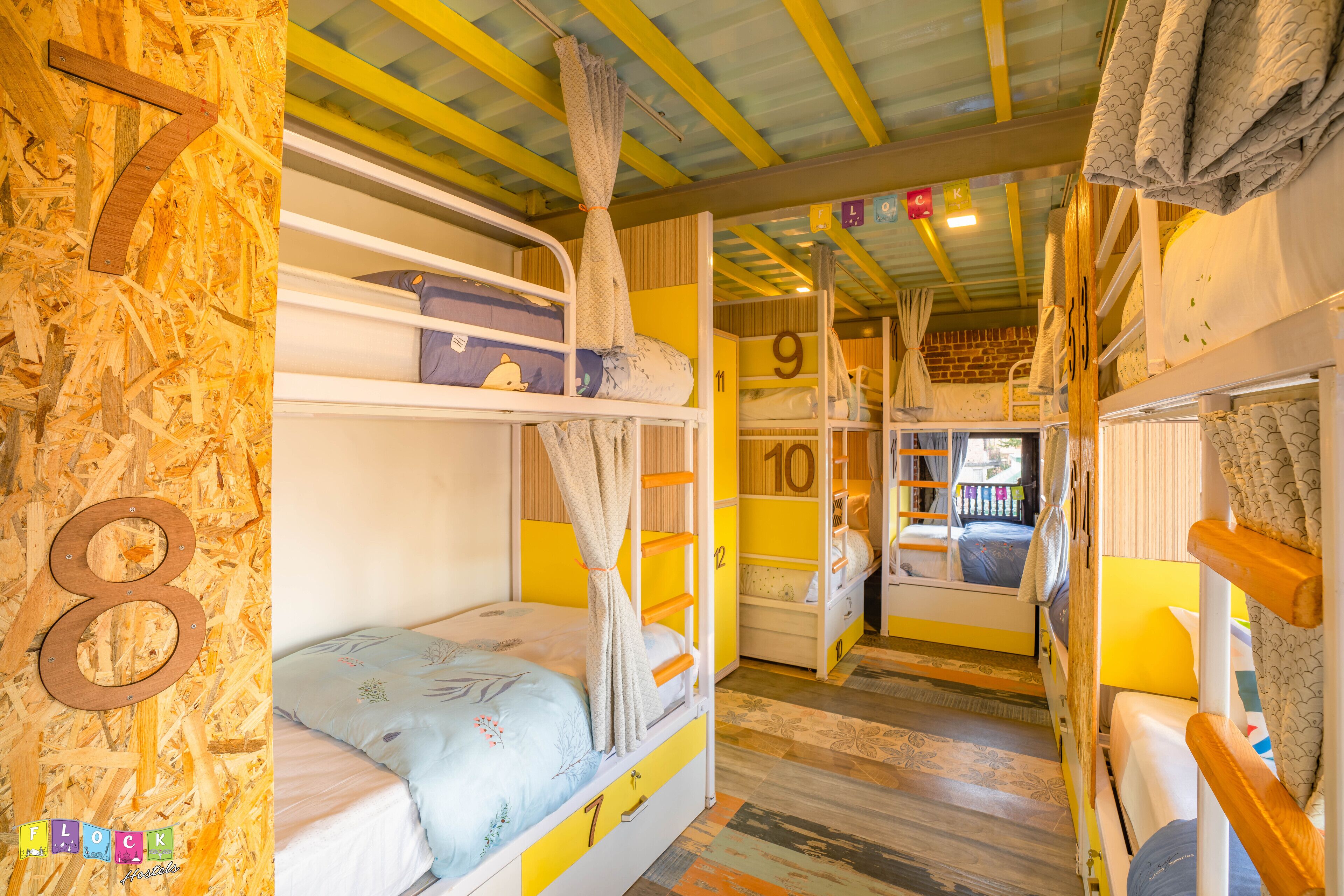 A bunk bed room with numbers on the walls indicating room numbers.