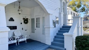 A white house with a porch, a mailbox, and a number 132 sign. - Luxurious and Relaxing Elegance Upstairs 🚭 (St. Augustine)