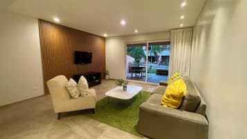 Basic Condo, 2 Bedrooms | Living area | 25-inch LED TV with cable channels, TV