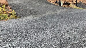 A red house with a metal roof, surrounded by a forest and a gravel driveway. - Spacious 3-Story Home, 4 bedrooms, Sleeps 12, Easy Trailer Parking (Detroit)