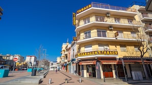 A building with multiple storefronts, including a tobacconist and a tobaccoswinkel.