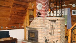 A rustic interior with a brick fireplace, wooden beams, and a staircase. - Beautiful private villa for 6 guests with WIFI, A/C, TV, patio and pets allowed (Malý Ratmírov)