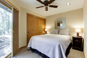 Relax in a spacious room with a large bed, bedside tables, and a ceiling fan.