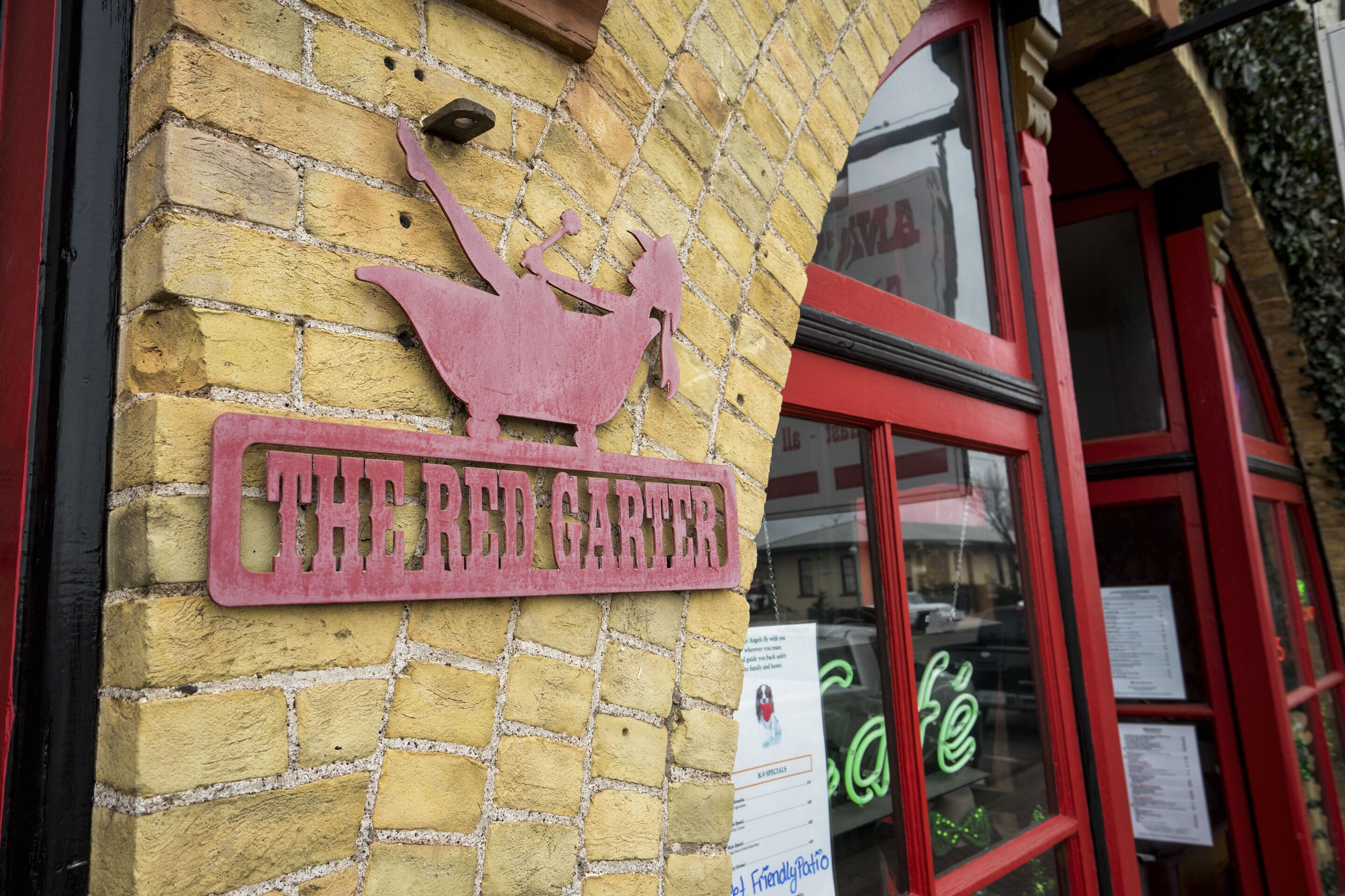 A brick building with a sign that reads "THE RED GARTER."