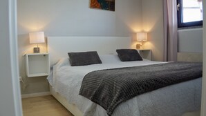 A neatly arranged bedroom with a bed, two bedside tables, and a wall-mounted shelf. - Apartment in Rovinj with Terrace, Air condition, WIFI, Washing machine (3652-3) (Rovinj)
