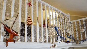 A staircase with a nautical theme, including a ship's wheel, a starfish, and a hammock. - Apartment in Rovinj with Terrace, Air condition, WIFI, Washing machine (3652-3) (Rovinj)