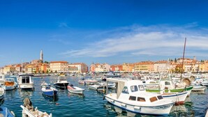 A marina with numerous boats docked, a historic town with colorful buildings in the background, and a clear blue sky. - Apartment in Rovinj with Terrace, Air condition, WIFI, Washing machine (3652-3) (Rovinj)
