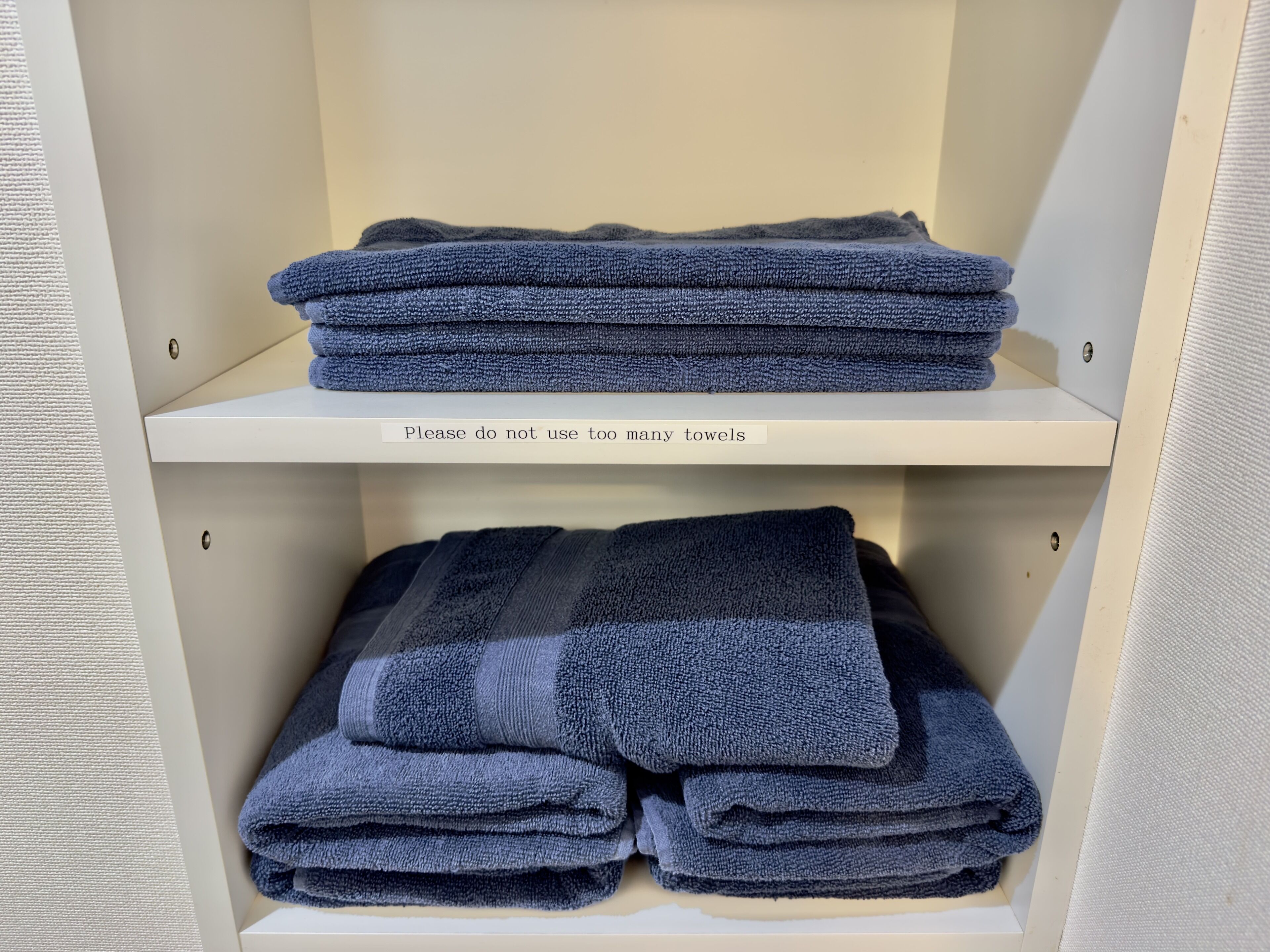 A storage unit with folded towels.