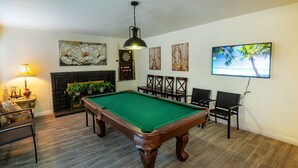 A pool table in a room with a fireplace, a television, and artwork on the walls. - Entire house, pool, minutes to strip, Sleeps 10! Only 3 miles away from Strips (Las Vegas)