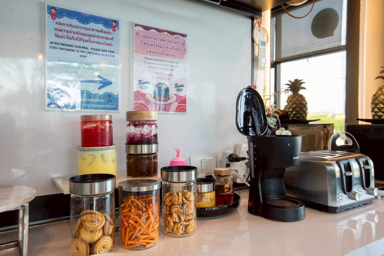A kitchen counter with various food items and kitchen appliances.