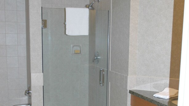 A bathroom with a glass-enclosed shower, a sink, and wooden cabinets. - Grand Marriott Resort in Heavenly Village (South Lake Tahoe)
