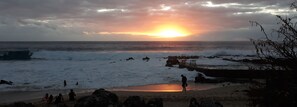 A beach with waves, a sunset, and rocky outcrops. - From Boucan Canot Beach... to the Bassin Bleu Golf Course. (Saint-Gilles-les Bains)