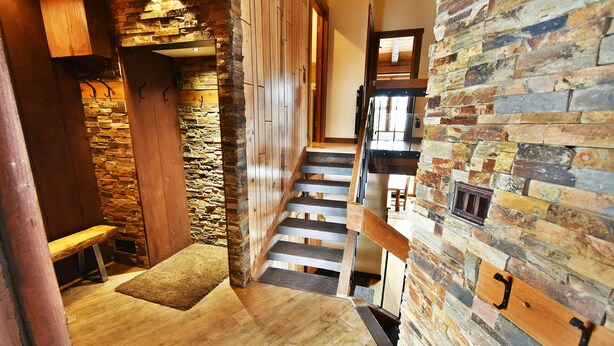 A wooden staircase with stone walls, a bench, and a fireplace. - Near Trails! Big Deck! Easy Drive to Dining, Events, Activities, Lake (Silverthorne)
