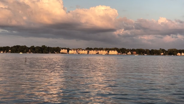 Een uitzicht op het water met een rij gebouwen langs de oever.