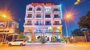 A hotel with a prominent sign, multiple balconies, and a well-lit entrance. - Winston Hotel Riverside (Ho Chi Minh City)
