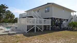 A two-story house with a raised deck and a pool. - Windjammer - Walk to Beach in Garden City Beach (Garden City)