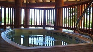 A wooden deck with a hot tub. - Some of the best direct ski access on the mountain!! 2 bedroom with beautiful valley views!! (Whitefish)