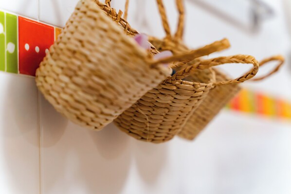 A close-up of woven baskets hanging on a wall.
