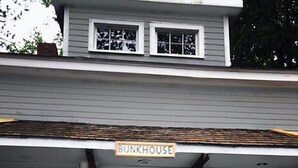 A two-story building with a sign reading "BUNKHOUSE" above the entrance. - 10+ Spacious Cape on Winnipesaukee Island. Private Peninsula. Sunset Views. (Meredith)