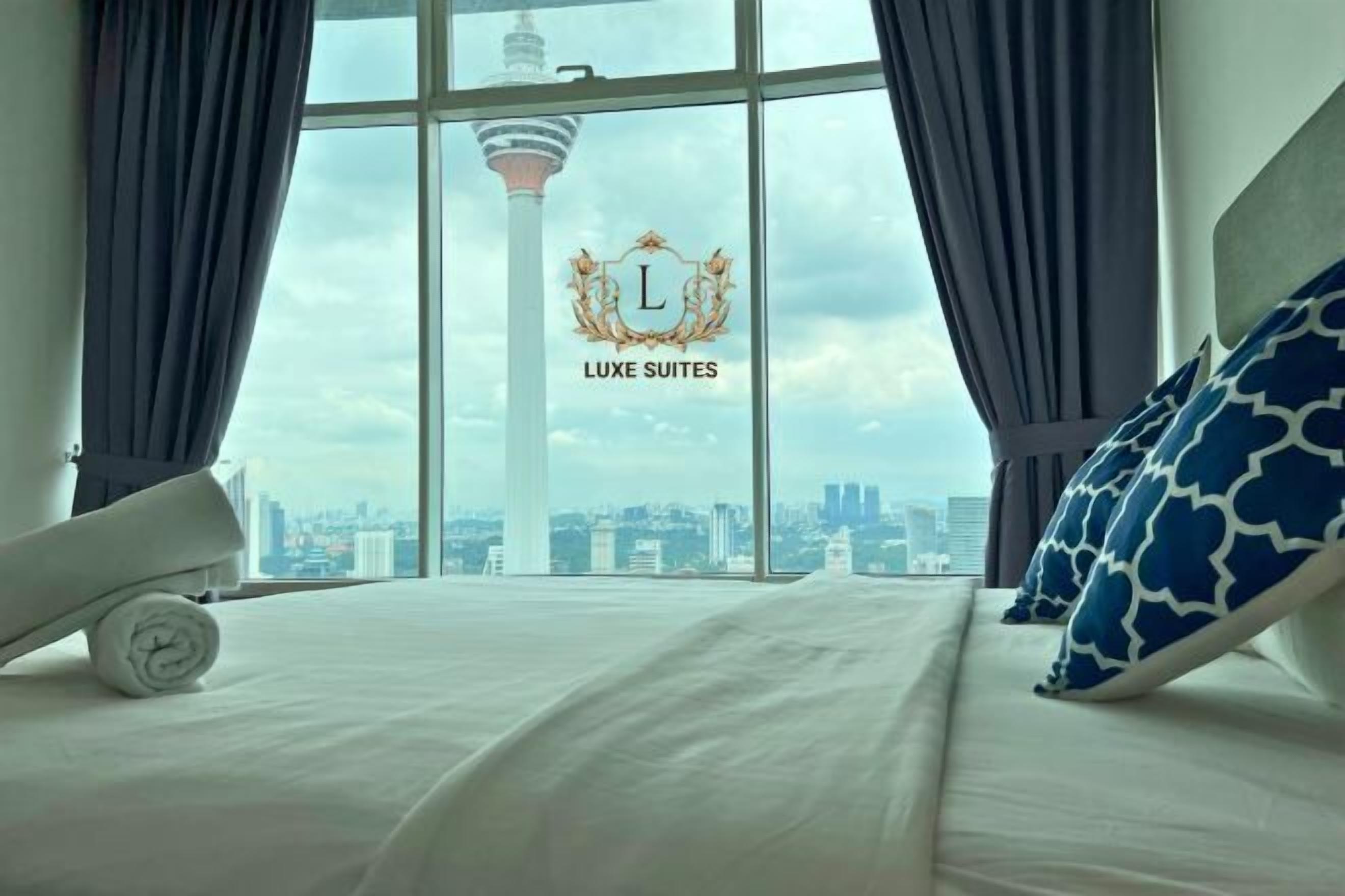 Laptop workspace, iron/ironing board, bed sheets