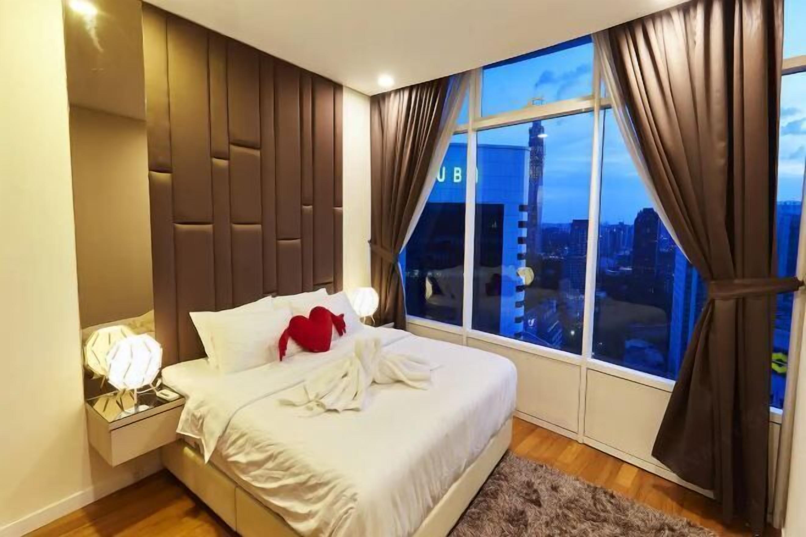 Laptop workspace, iron/ironing board, bed sheets