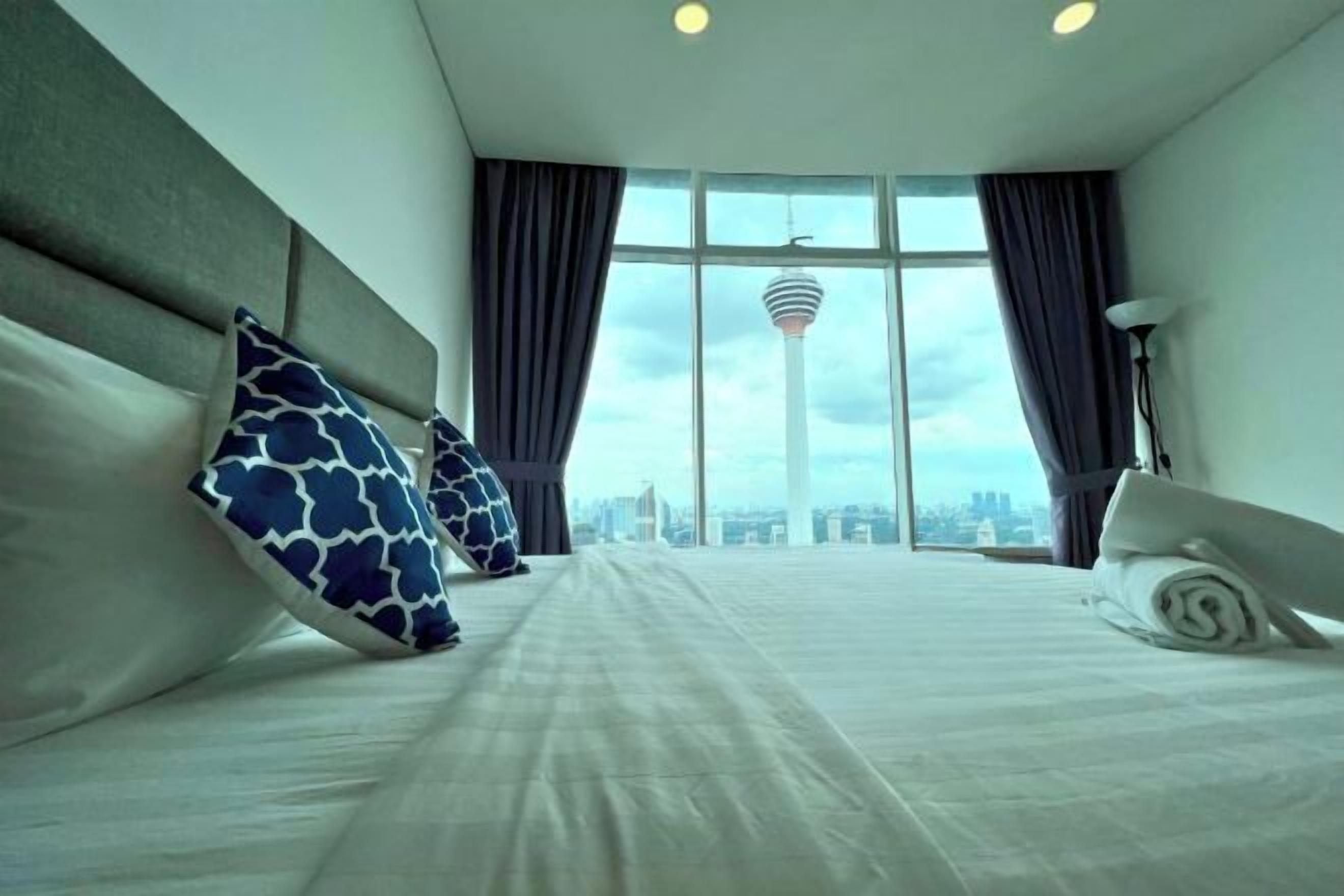 Laptop workspace, iron/ironing board, bed sheets