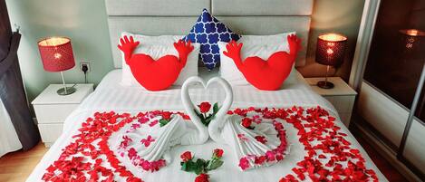 Laptop workspace, iron/ironing board, bed sheets