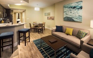 Relax in a comfortable living room with a sofa, coffee table, and dining area.