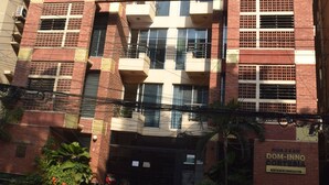 A multi-story building with balconies, a gated entrance, and a sign indicating it is a residential complex. - Fairmont Guest House (Dhaka)