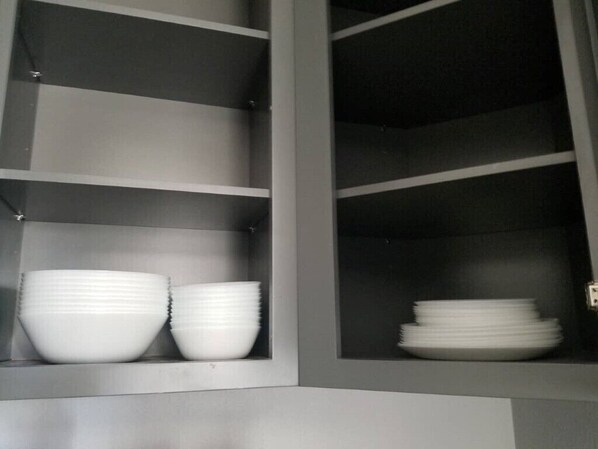 A kitchen cabinet with shelves holding white bowls and plates. - COZY HOME 8 MINUTES to Disneyland, close Little Saigon,Beach (Anaheim)