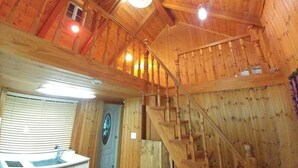 A wooden interior with a staircase, a sink, and a window with blinds. - Yangsan Park Pension (Yangsan)