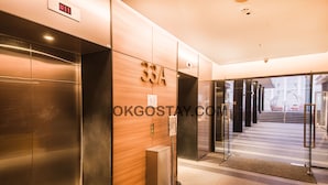 An elevator with a wooden panel and the number 33A. - Zenith Suites JBCC by OKGOSTAY (Johor Bahru)