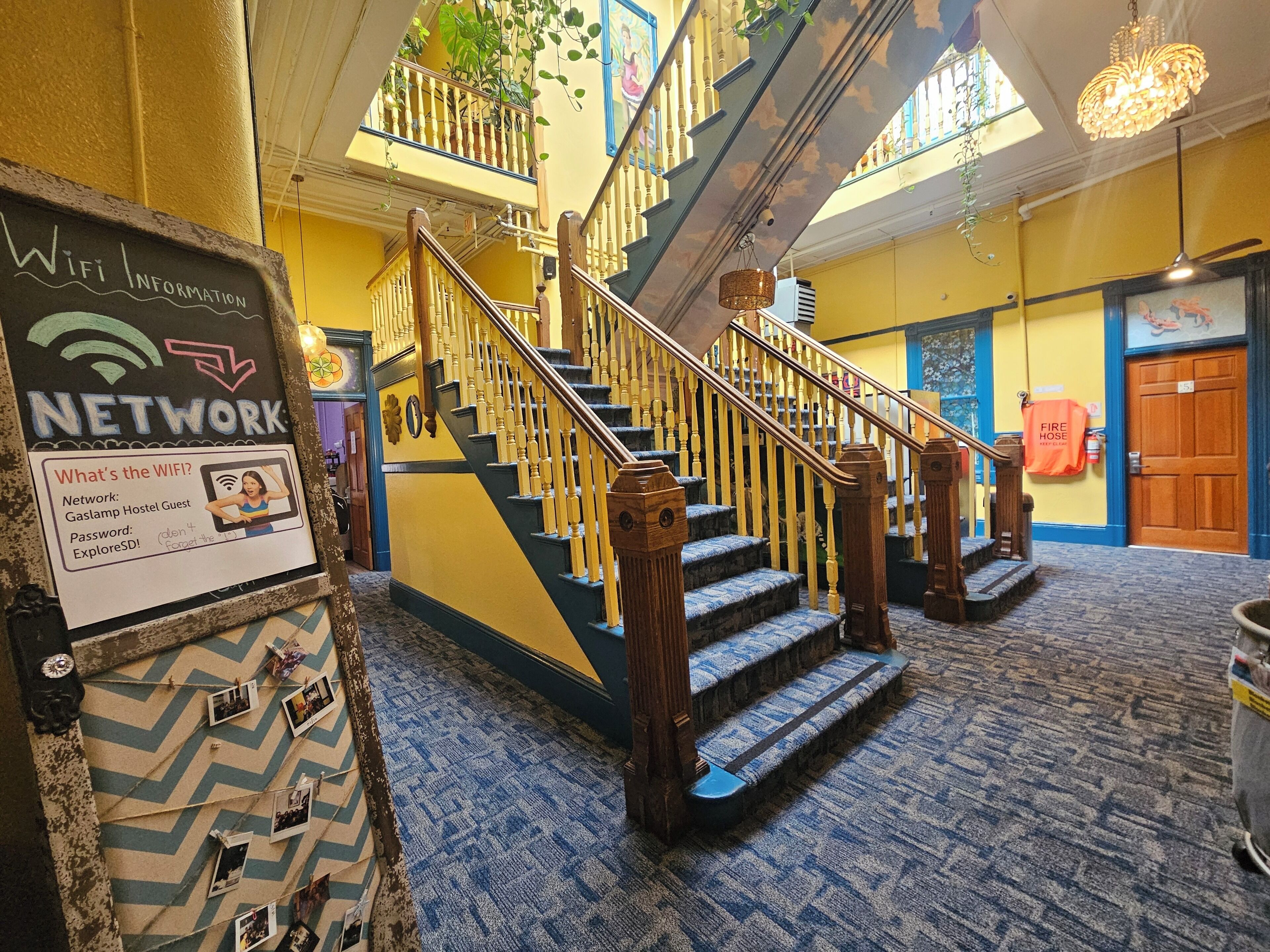 A staircase with wooden balusters and a chevron-patterned carpet.