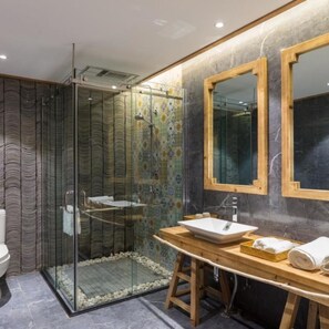 A modern bathroom with a glass-enclosed shower, a wooden vanity with a vessel sink, and a large mirror above the sink. - Floral Hotel · Zai Yi Qi Lijiang (Lijiang)