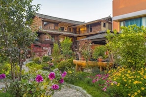 A traditional wooden building with a garden in front.