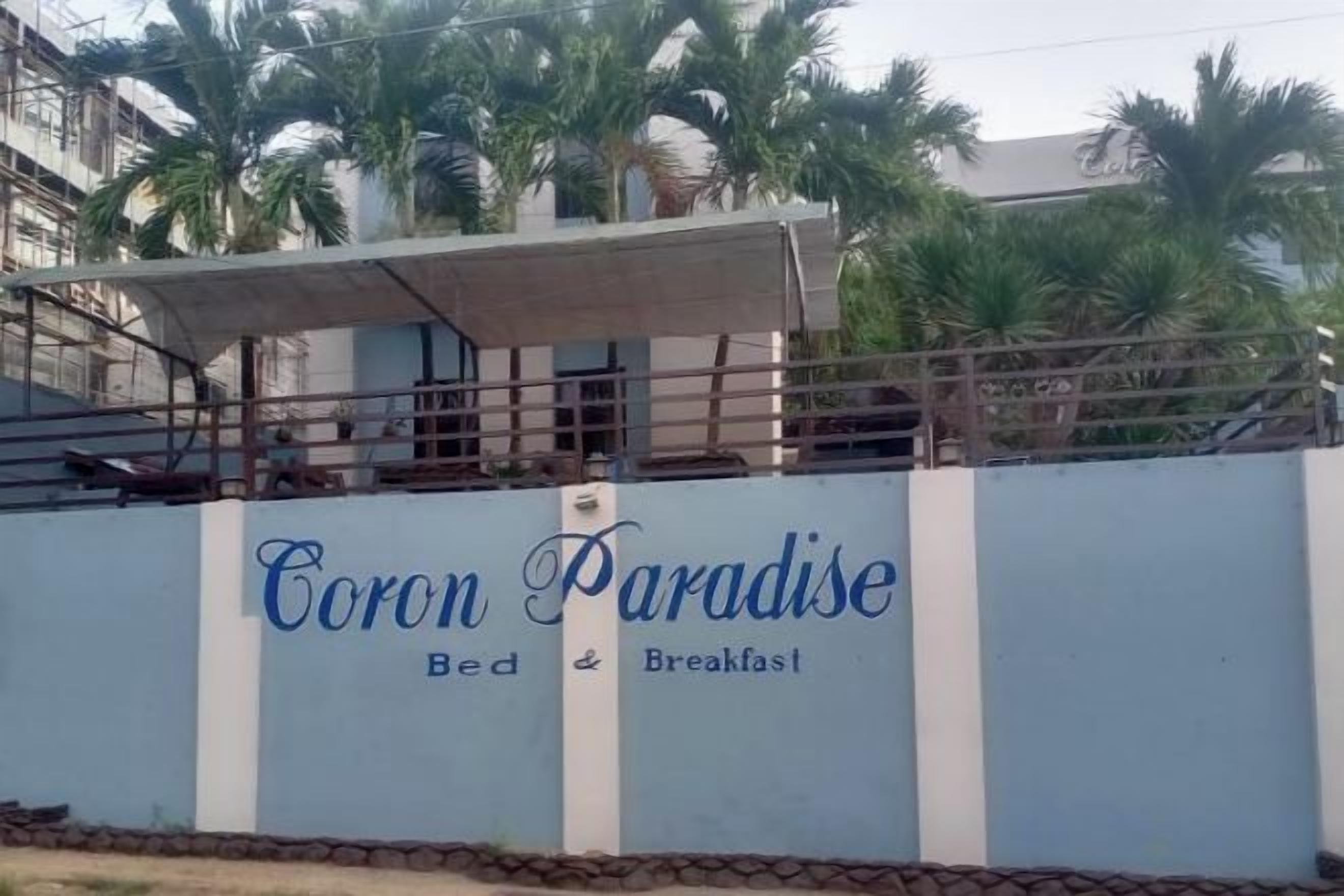 A hotel named 'Coron Paradise' with a sign indicating it offers bed and breakfast services.