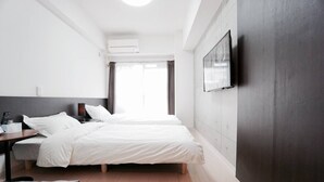 A modern hotel room with two beds, a desk, and a TV. - Hostel 758 Nagoya2S (Nagoya)