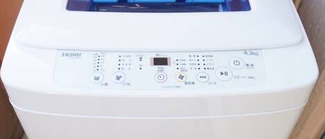 A white Haier air conditioner unit with a digital control panel and a blue air flow indicator.