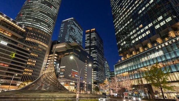 A modern urban skyline with high-rise buildings, including a distinctive curved structure in the foreground. - Hostel 758 Nagoya3C (Nagoya)