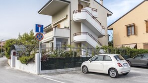 A multi-story building with a white facade, balconies, and a gated entrance. - N164 - Numana, two-room apartment with wonderful sea view (Numana)
