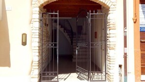 A stone archway leading to a staircase.