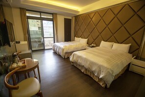 Two double beds with plush headboards, a desk, and a glass cabinet.